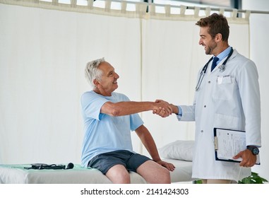 Looks Like Weve Reached Our Goal. Cropped Shot Of A Young Male Doctor Shaking Hands With An Elderly Patient In His Office.