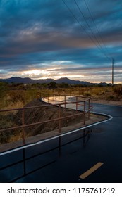 The Loop In Tucson, Arizona. A Walking, Running And Biking Path. A Beautiful Sunset With Wet Pavement Picking Up The Light And Reflecting It. The Railing Disappears In The Distance, Nice Lines. 2018