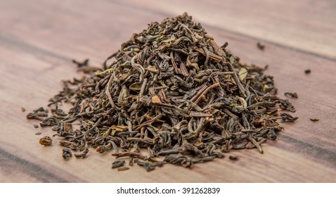 Loose Dried Darjeeling Black Tea Leaves Over Wooden Background