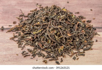 Loose Dried Darjeeling Black Tea Leaves Over Wooden Background