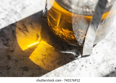 Loose leaf tea steeps in a french press on a white marble counter top. - Powered by Shutterstock