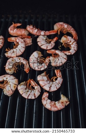 loose prawns with shell on the barbecue grill, shrimp on the barbie