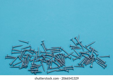 Loose Screws On A Blue Background