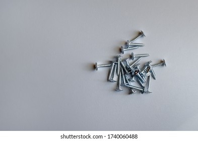 Loose Screws On A Grey Background