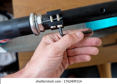 loosening the screw with a hex wrench. repair of household items at home.