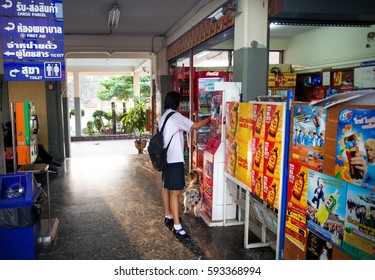 Lopburi, Thailand - November 21, 2016: Schoolgirl With Dog Near Ticket Machine At Public Train Station