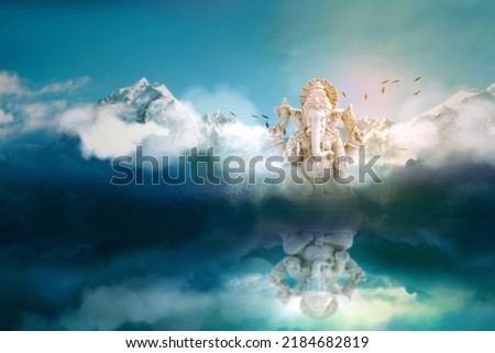 Lord ganesha sculpture on mountain and sky background.