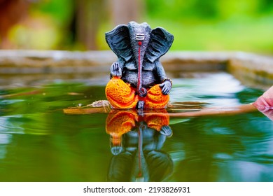Lord ganesha sculpture on nature background.