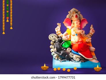 Lord Ganpati idol statue for Happy Ganesh Chaturthi festival of India - Shutterstock ID 1799477731