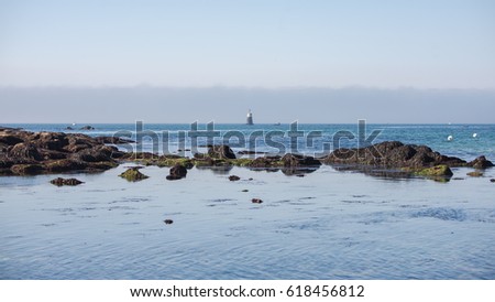 Lorient, Larmor Plage, beach, low tide with lighthouse in sunlight