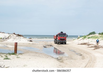 a lorry at the beach, working har