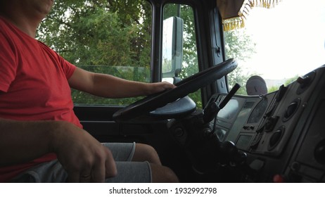 Lorry Driver Holding Hand On Steering Wheel And Driving Car At Country Road. Man Shifting Gears In A Manual Transmission And Controlling Truck. Trucker Riding To Destination. Close Up Crane Shot.