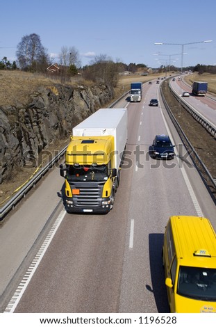 lorry surrounded by traffic
