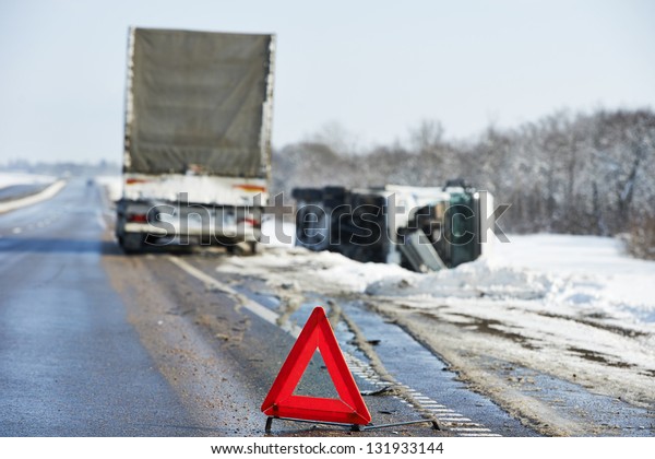 Lorry trailer car crash smash accident on\
an slippery winter snow interstate\
road