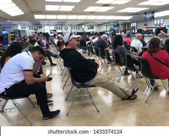 LOS ANGELES, April 25, 2019: DMV Department Of Motor Vehicles Culver City. Long Rows Of Chairs With People Sitting, Waiting Their Turn, Inside The Busy Waiting Room Area.