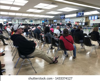 LOS ANGELES, April 25, 2019: DMV Department of Motor Vehicles Culver City. Long rows of chairs with people sitting, waiting their turn, inside the busy waiting room area.