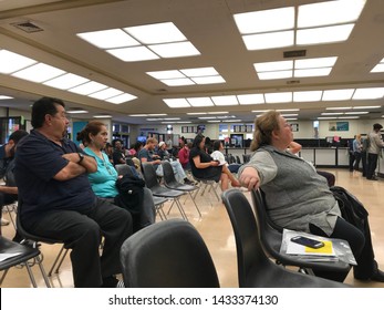 LOS ANGELES, April 25, 2019: DMV Department Of Motor Vehicles Culver City. Long Rows Of Chairs With People Sitting, Waiting Their Turn, Inside The Busy Waiting Room Area.