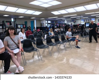 LOS ANGELES, April 25, 2019: DMV Department Of Motor Vehicles Culver City. Long Rows Of Chairs With People Sitting, Waiting Their Turn, Inside The Busy Waiting Room Area.