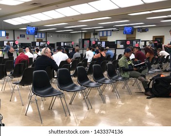 LOS ANGELES, April 25, 2019: DMV Department Of Motor Vehicles Culver City. Long Rows Of Chairs With People Sitting, Waiting Their Turn, Inside The Busy Waiting Room Area.