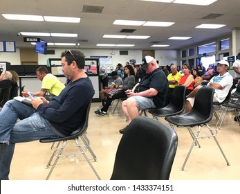 LOS ANGELES, April 25, 2019: DMV Department Of Motor Vehicles Culver City. Long Rows Of Chairs With People Sitting, Waiting Their Turn, Inside The Busy Waiting Room Area.