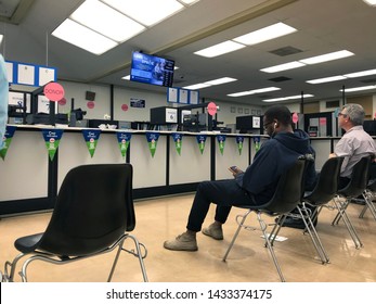 LOS ANGELES, April 25, 2019: DMV Department Of Motor Vehicles Culver City. People On Chairs Sitting Near The Counters Inside The Waiting Room Area.