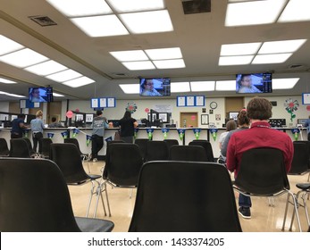 LOS ANGELES, April 25, 2019: DMV Department of Motor Vehicles Culver City interior. Long rows of empty chairs with only a few people inside the waiting room area on a not so busy day.