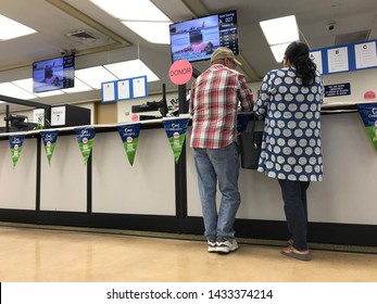 LOS ANGELES, April 25, 2019: DMV Department of Motor Vehicles Culver City interior. Close up of a couple standing at the counter at the DMV field office.