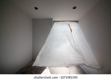 Los Angeles, CA - April 14, 2018.
Empty room interior with flying plastic sheet cover over the wall opening for protection while the construction is in progress.