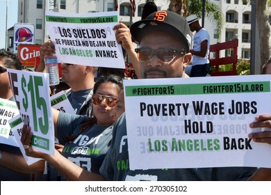 LOS ANGELES, CA   APRIL 15, 2015: Protestor Hold Signs Advocating Raising The Minimum Wage At During A Rally In Los Angeles On April 15, 2015.