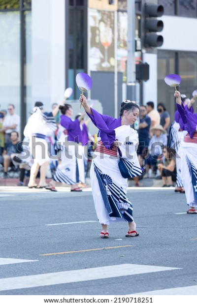 Los\
Angeles, CA - August 14 2022:  Japanese dancers in traditional\
clothing perform in the Nisei parade in Little\
Tokyo