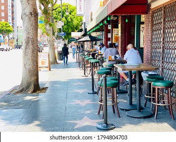 Los Angeles, CA - August 5, 2020: Outdoor Dining At A Pub House On Hollywood Blvd During Covid 19 Pandemic.