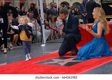 LOS ANGELES, CA - DECEMBER 15, 2016: Actor Ryan Reynolds & wife actress Blake Lively & daughters James Reynolds (2) & baby at the Hollywood Walk of Fame Star Ceremony honoring Ryan Reynolds.

