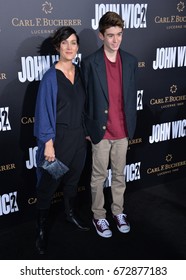 LOS ANGELES, CA - JANUARY 30, 2017: Carrie-Anne Moss & Owen Roy at the premiere of "John Wick Chapter Two" at the Arclight Theatre, Hollywood.