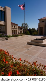 Los Angeles, CA - June 11 2021:  Flag Waving Over Orange Flowers On The Campus Of Occidental College