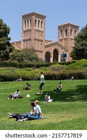 Los Angeles, CA - May 17 2022:  Students Relax On A Sunny Day At UCLA With A Student Walking On A Tightrope