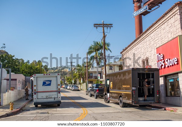 Los Angeles, CA: May 17, 2018:  United Parcel\
Service (UPS) truck and United States Postal Service (USPS) parked\
outside the UPS store. United Parcel Service is an American\
multinational company.