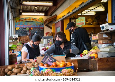 Los Angeles, CA / United States - 04/05/20: Grocery Store Workers Prepare Food While Wearing Face Masks And Gloves During The COVID-19 Epidemic