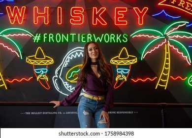 Los Angeles, CA/ USA 06-18-2020
A Girl Pictured In Front Of A Wall Of Neon Signs, Located In The Grand Central Market In Downtown LA