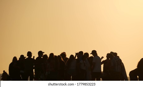 LOS ANGELES CA USA - 16 NOV 2019: California, Happy Young Multiracial Friends Having Fun And Hanging Out. Group Of Multiethnic People Dancing On Party In Sunset Light. Venice Beach Summertime Leisure.