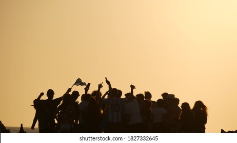 LOS ANGELES CA USA - 16 NOV 2019: California, Happy Young Multiracial Friends Having Fun And Hanging Out. Group Of Multiethnic People Dancing On Party In Sunset Light. Venice Beach Summertime Leisure.