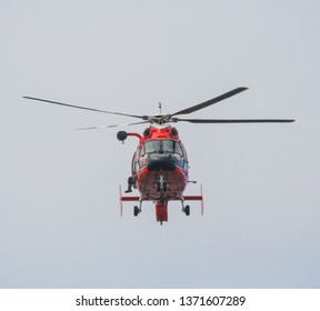 Los Angeles, CA / USA - February 14, 2006: A Bright Red US Coast Guard Dolphin Helicopter Conducts Training Rescue Operations Off Point Vicente Hovering Directly Overhead