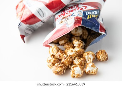 Los Angeles, CA. USA January 31st, 2022 Open bag of cracker jack brand popcorns and peanuts snack on white background from above