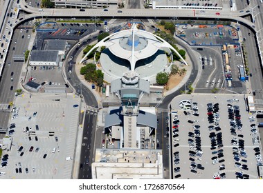 Los Angeles, CA / USA - July 15 2015: Air Traffic Control tower (ATC) and the iconic Theme Building at LAX Airport. Multiple parking lots around Center Way and World Way Road.