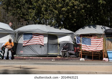 Los Angeles, CA USA - Julyl 3, 2021: Homeless veteran beside his tent on the permieter of the Veterans Administration grounds