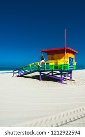 Los Angeles, CA / USA - June 10 2018: Girl Sitting On A Rainbow Lifeguard Tower In Santa Monica Beach, California