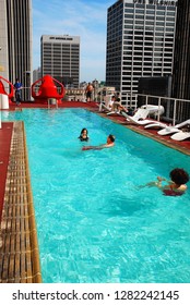 Los Angeles, CA, USA March 16 A Family Swims In Their Hotel's Roof Top Swimming Pool In Downtown Los Angeles