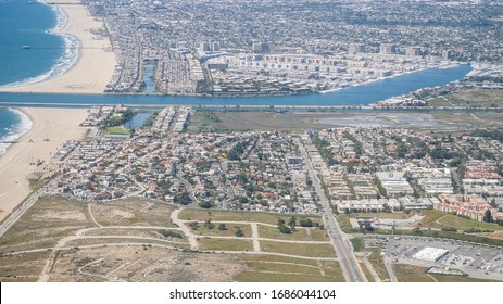 Los Angeles, CA / USA - March 27 2020. Empty beaches and streets on a Friday afternoon during the Coronavirus pandemic. Taking off from LAX. No smog due to reduced traffic