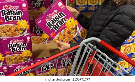 Los Angeles, CA, USA March 12th 2022 Shoppers Hand Holding A Package Kellogg's Brand Raisin Bran Flakes Cereal For Sale In A Supermarket Aisle