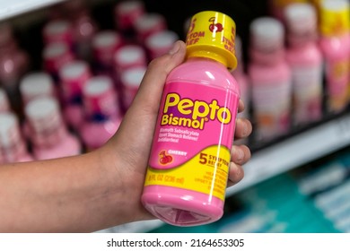 Los Angeles, CA, USA May 31st 2022 Customer Hand Holding A Bottle Container Of PEPTO BISMOL Stomach Antidiarrheal Medicine In A Supermarket Aisle