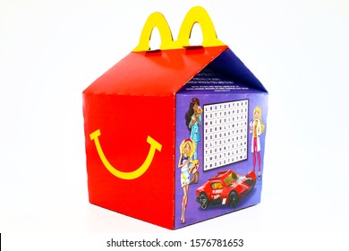 Los Angeles, California – December 2, 2019: McDonald's Happy Meal cardboard box with printed Mattel Barbie and Hot Wheels Toys. McDonald's is a fast food restaurant chain.